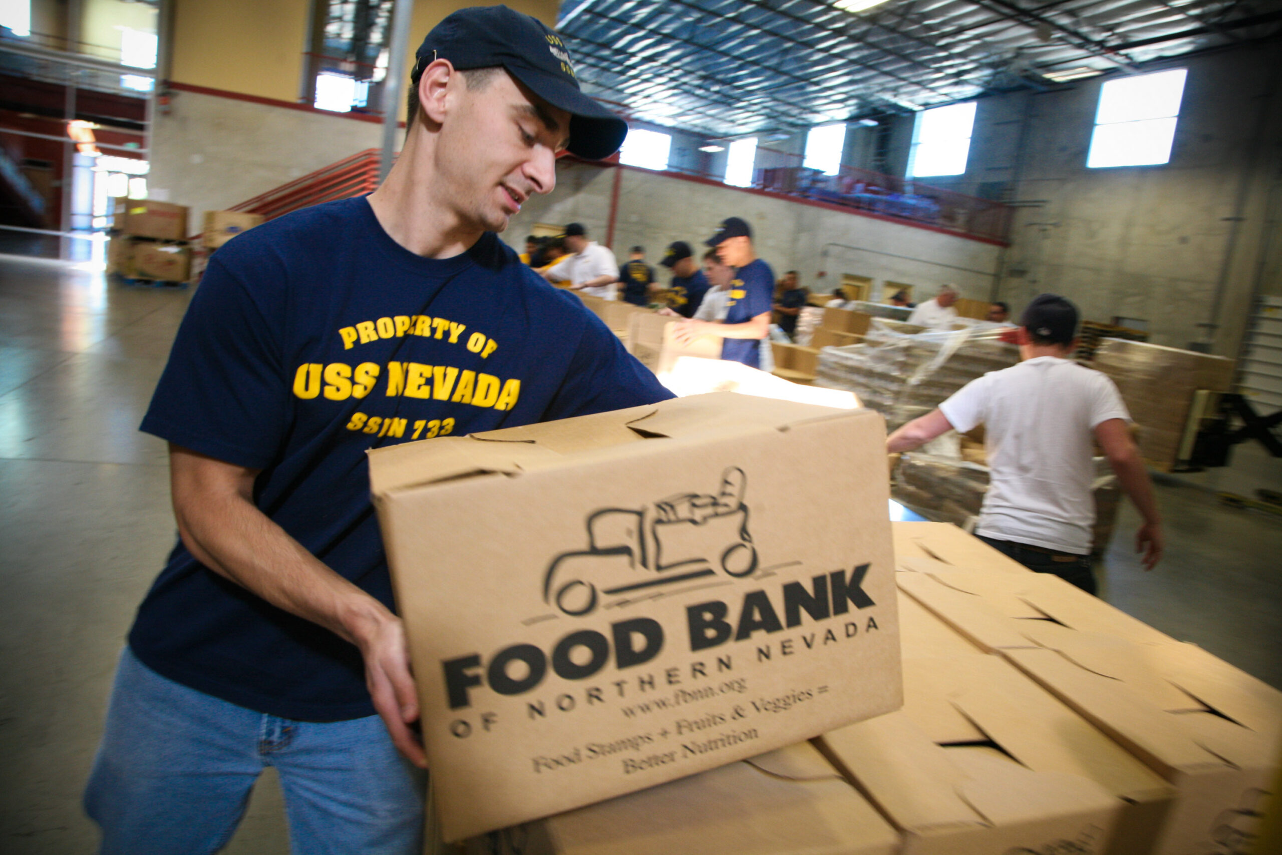 A Navy family packing moving boxes