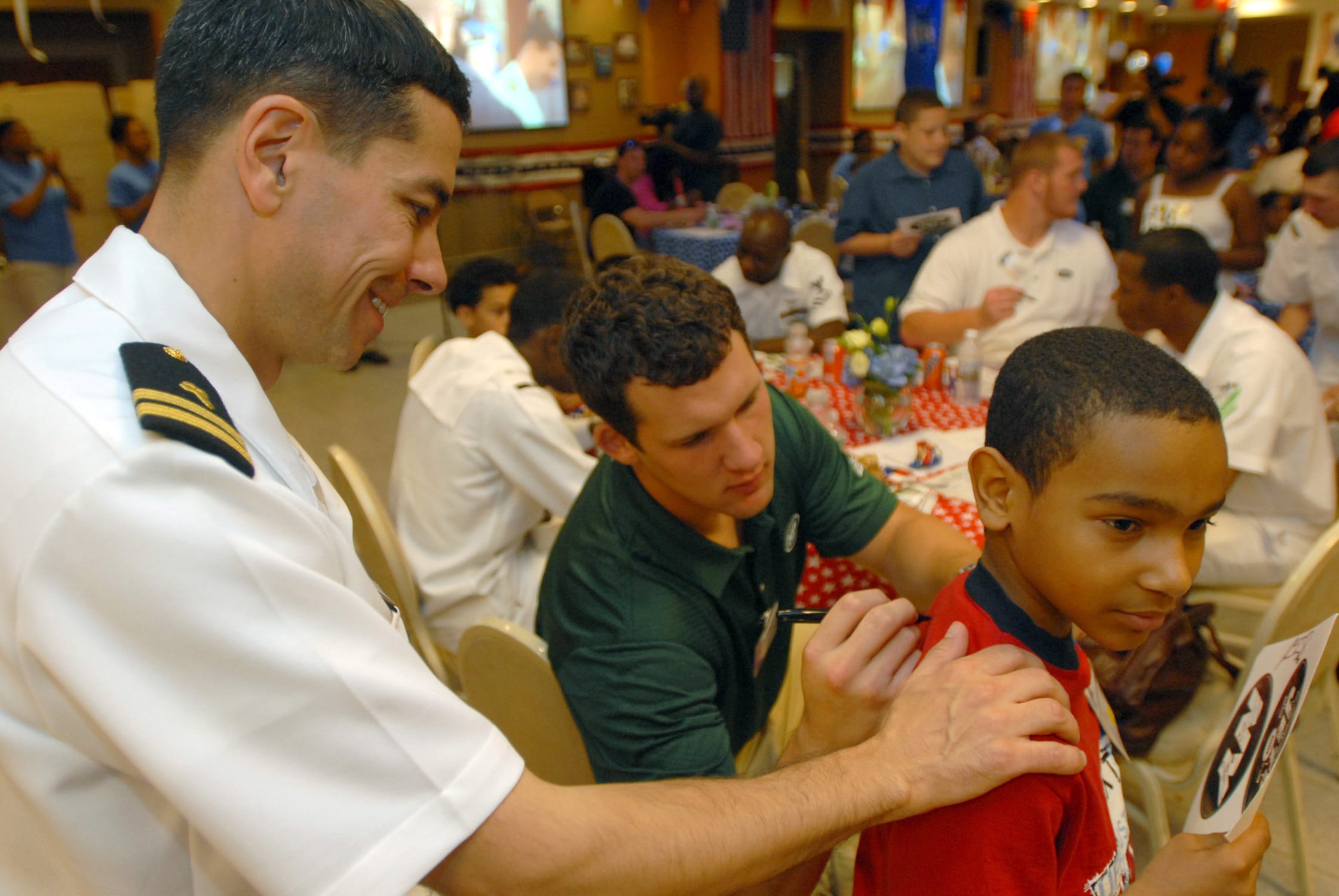 Navy chaplain talking privately with a sailor in a ship passageway