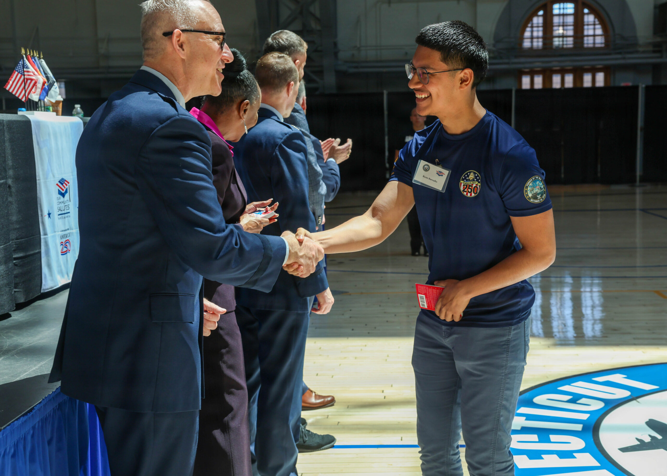 Navy recruiter with a new enlistee after signing