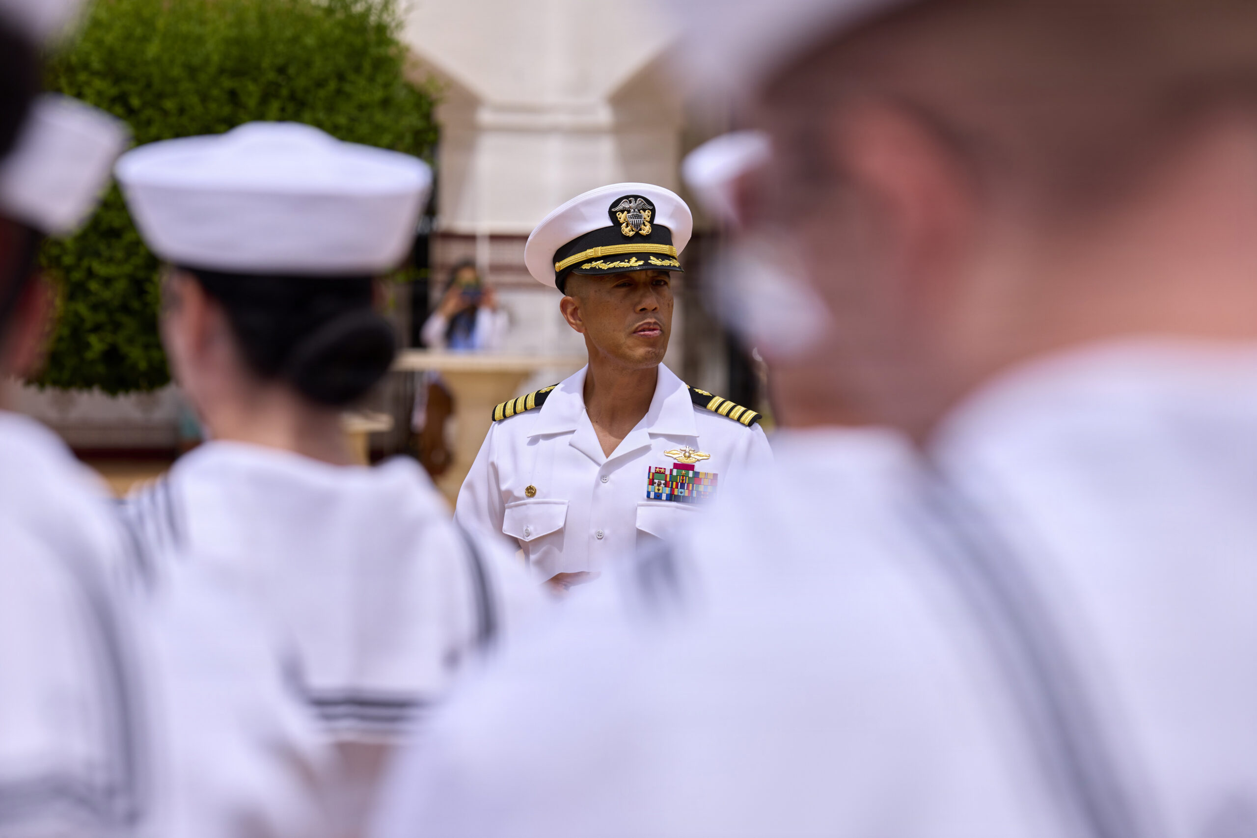 A Navy officer in service dress blues, representing the authority behind overseas screening guidance