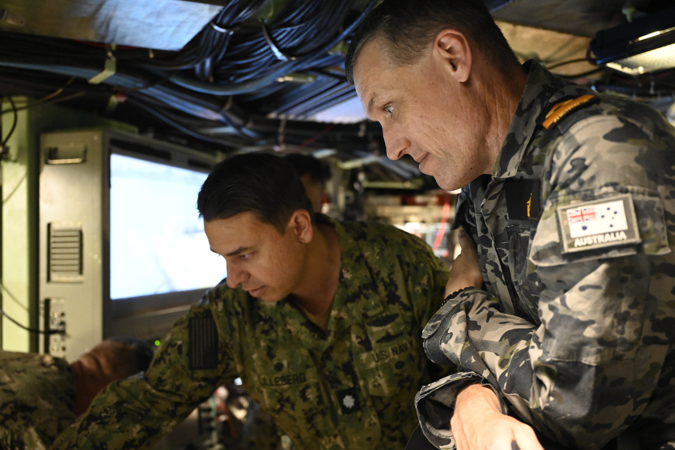 Navy intelligence officer briefing a commanding officer