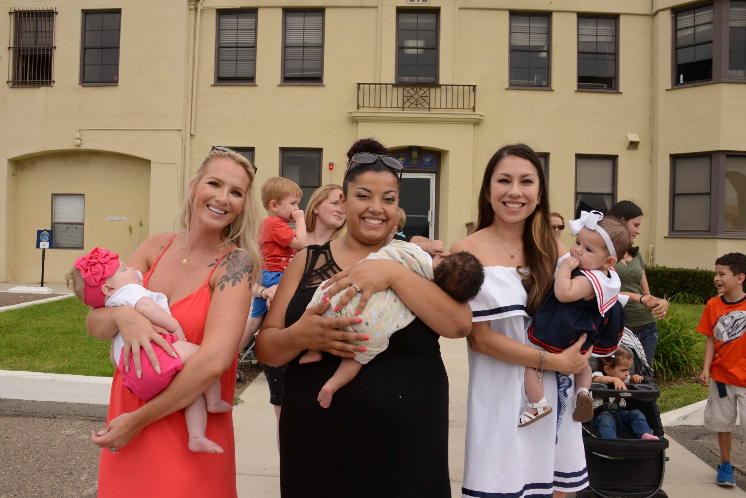 Active duty Navy mother holding her baby at home
