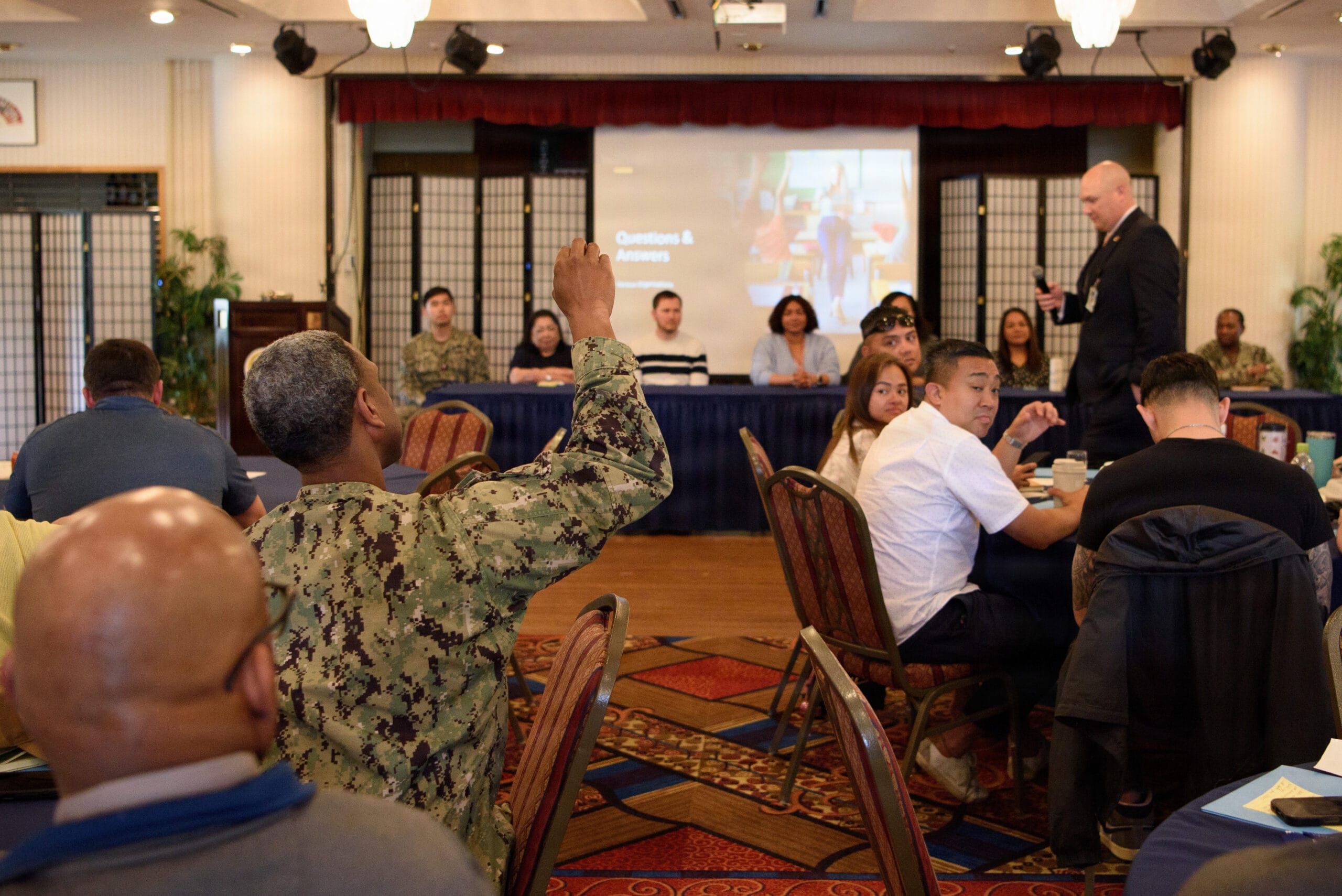 A Navy officer in uniform looking at retirement savings charts