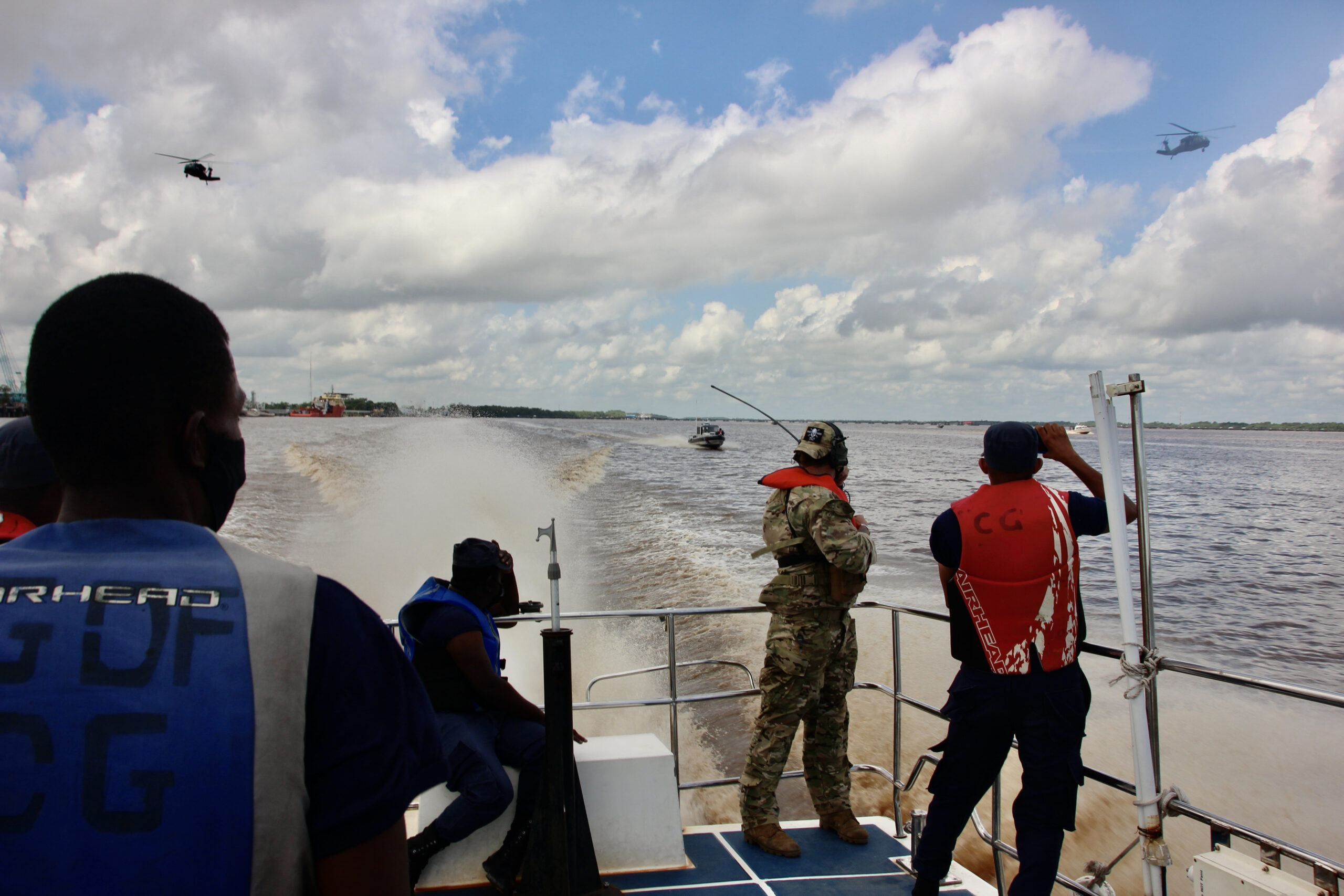 Coast Guard helicopter flying over ocean during drug interdiction