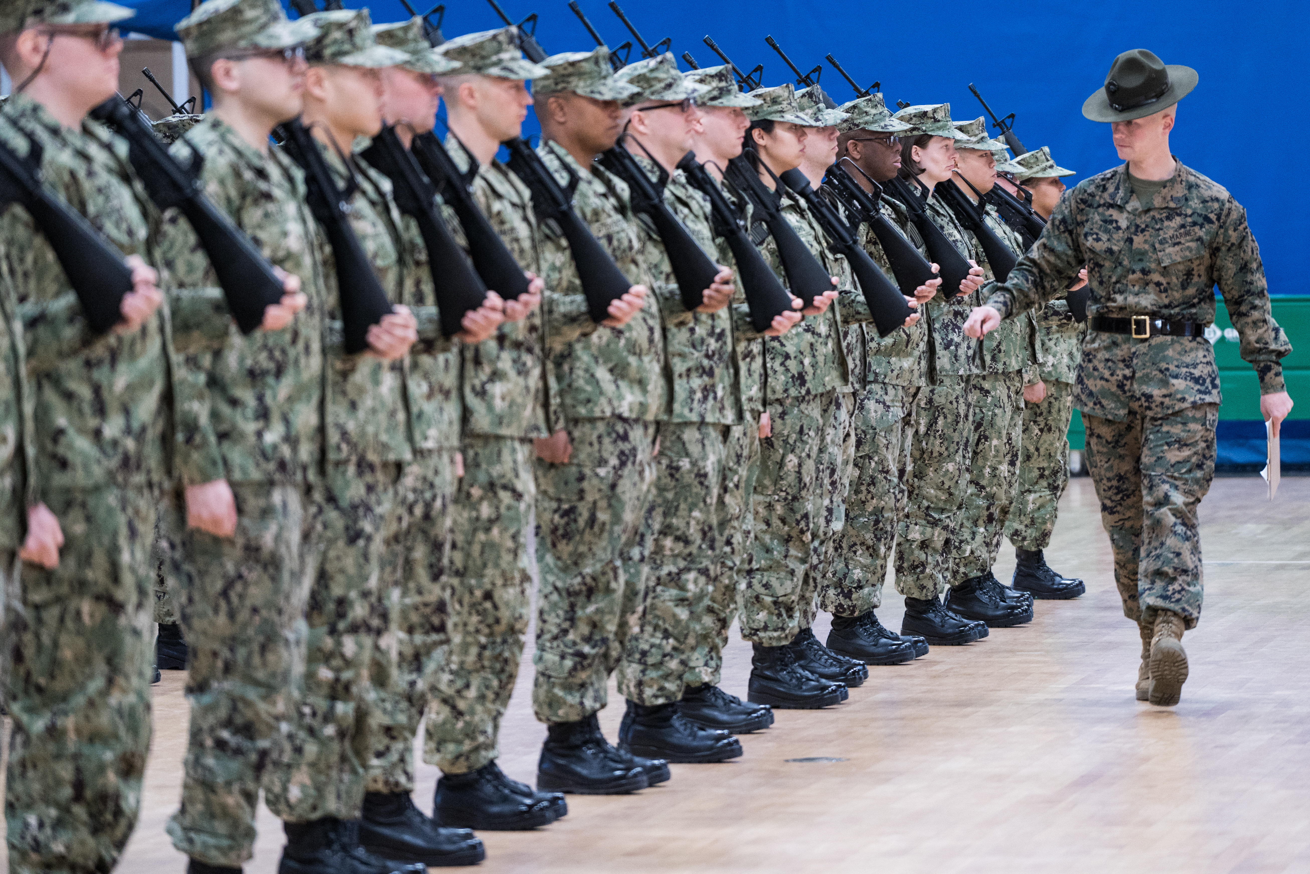 A Marine Corps drill instructor evaluating an OCS class formation during drill at Newport