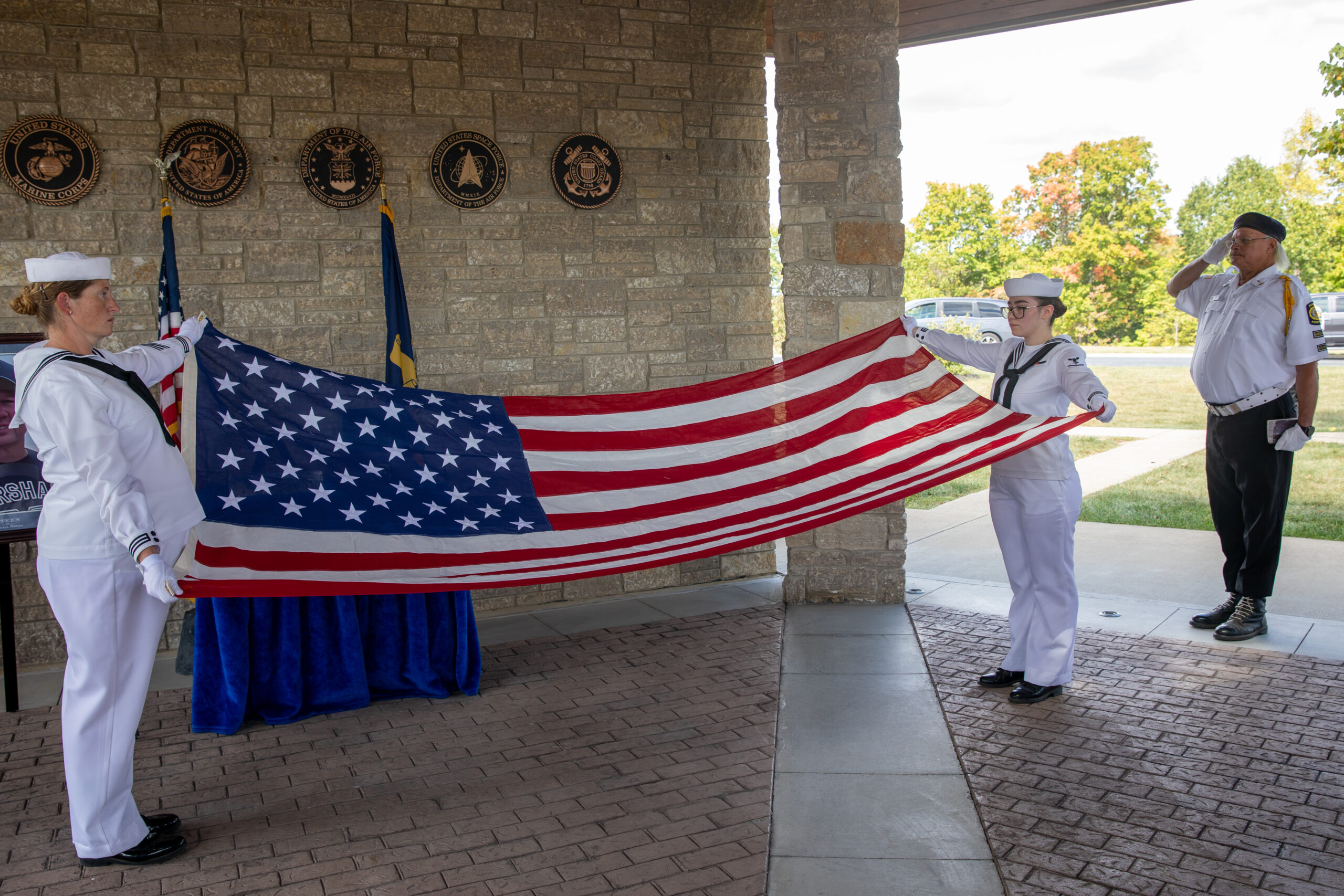 Navy funeral honors ceremony with flag presentation